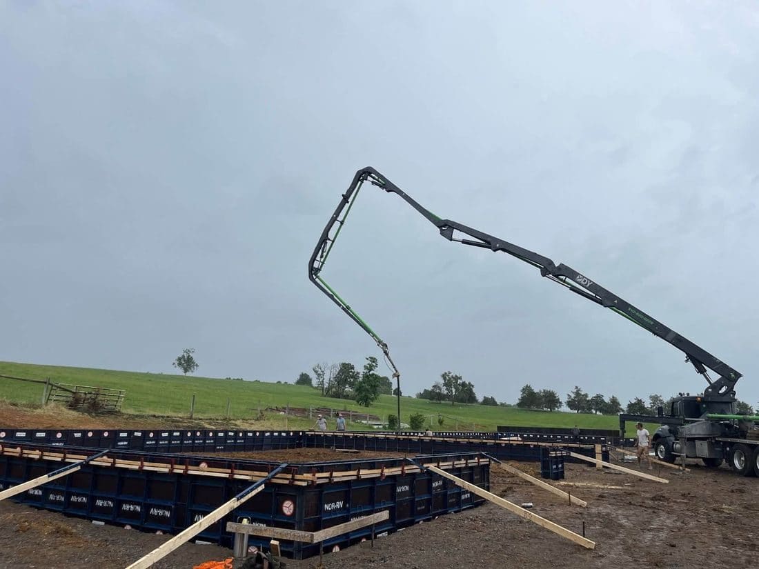Concrete being placed into set forms